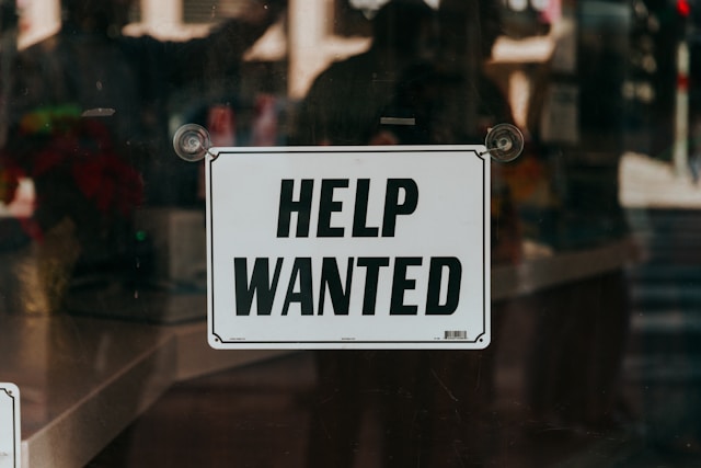 help wanted sign on a window